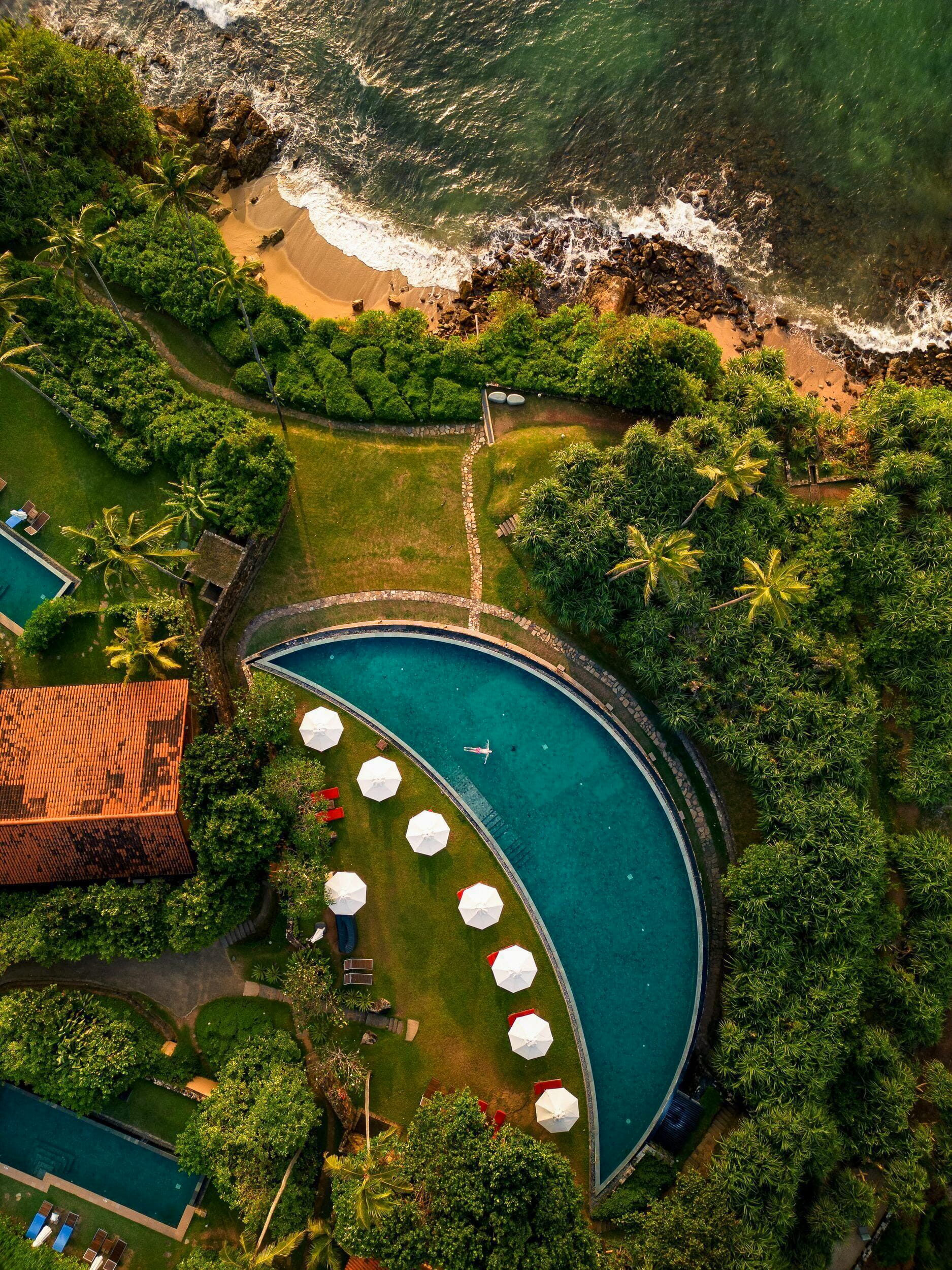 Cape Weligama crescent moon pool clifftop aerial view