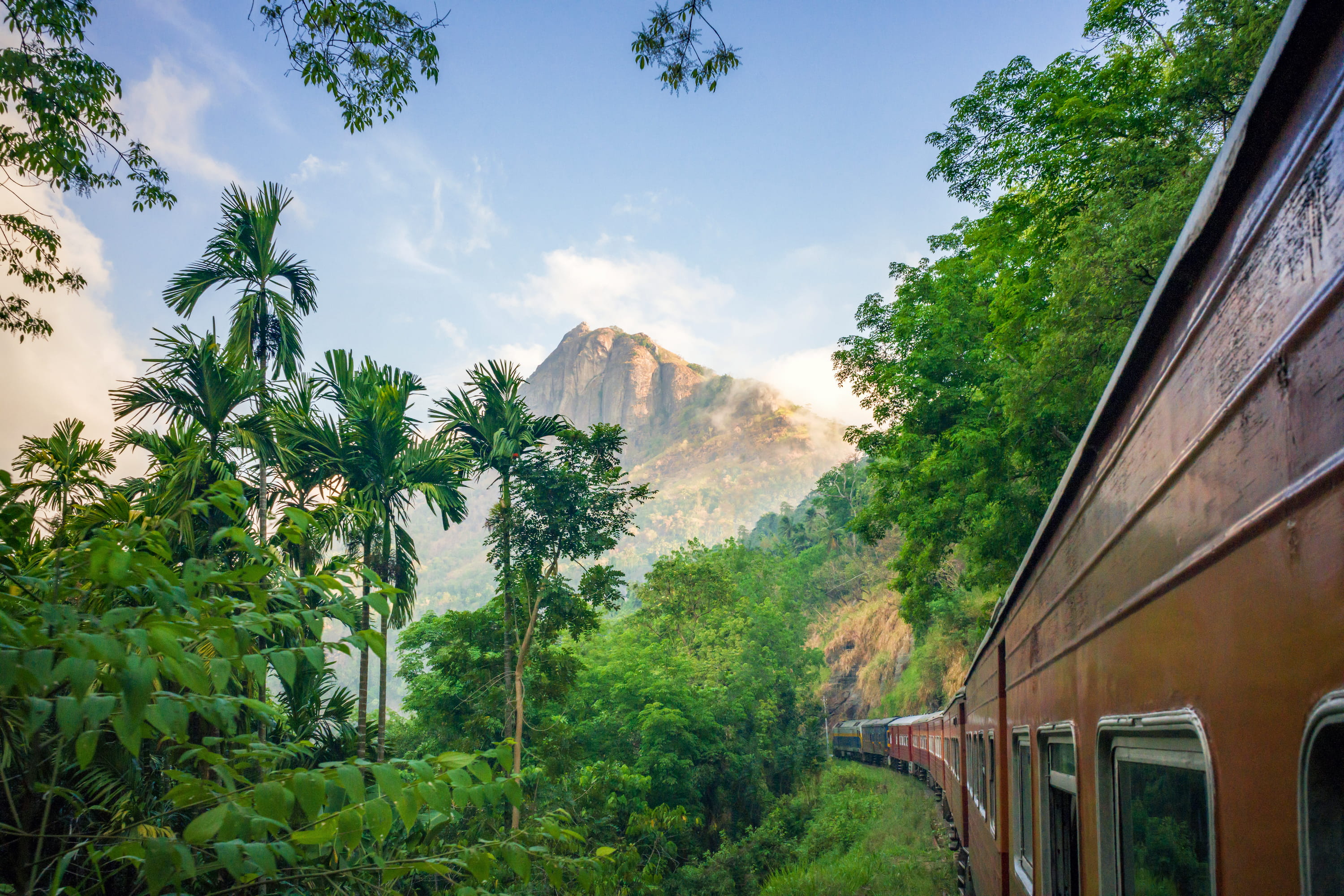 Hill country train passing rocky peak