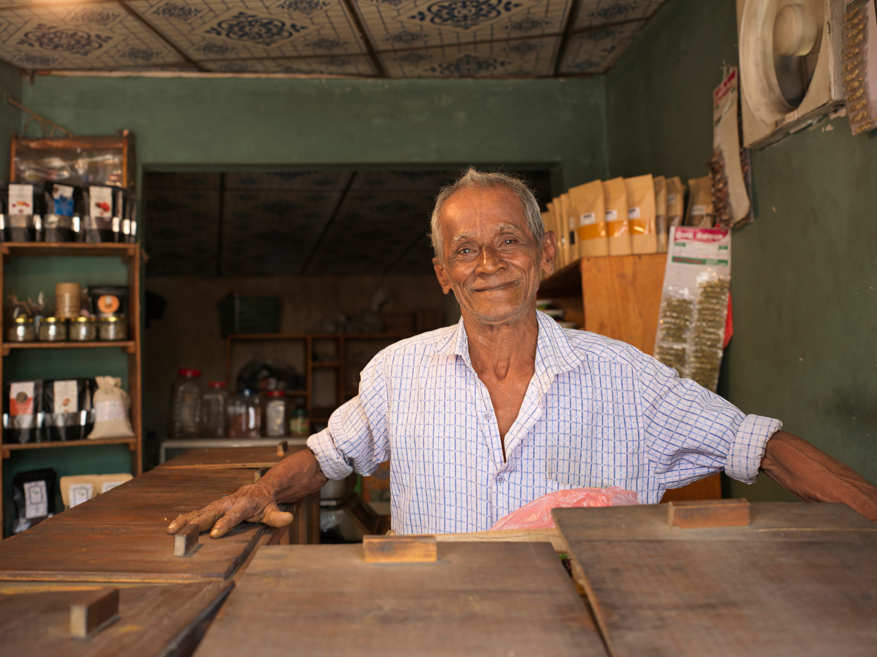 Local Sri Lankan spice shop owner standing in his traditional store